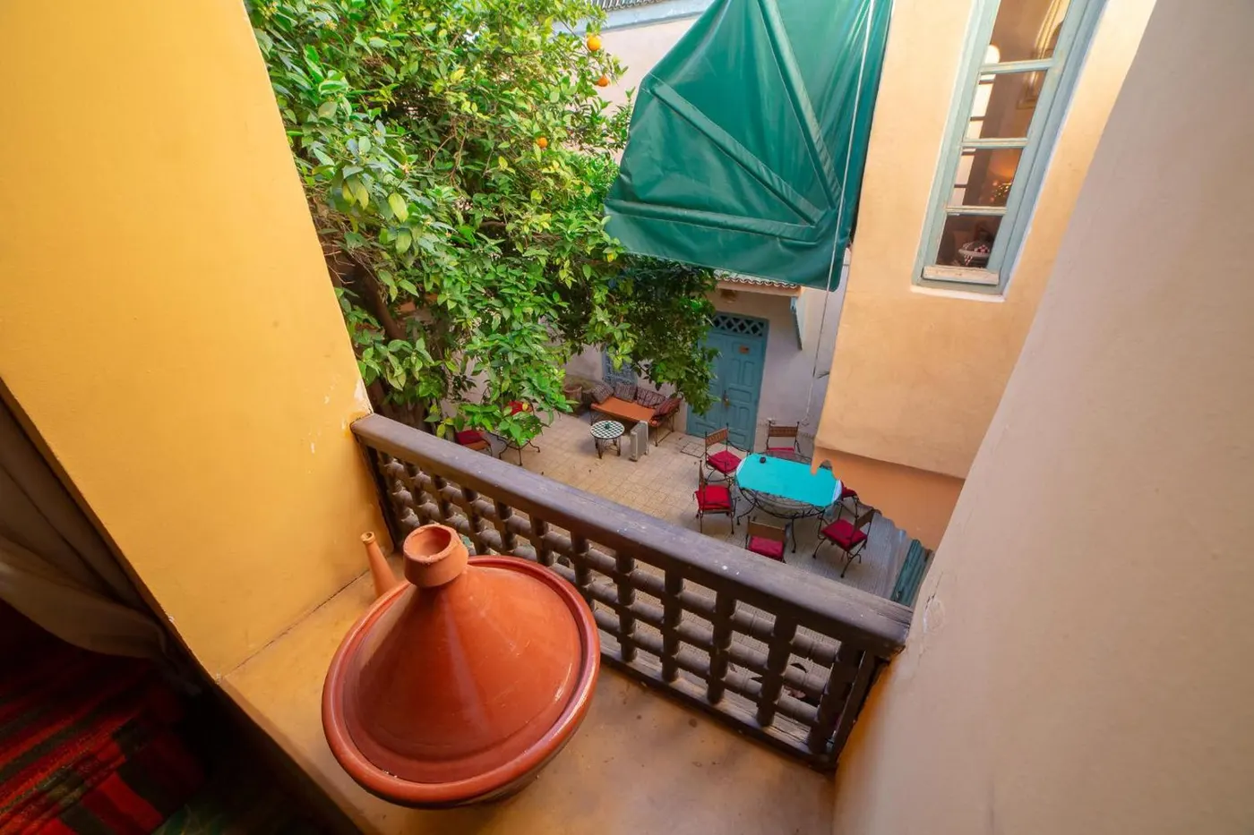 Tagine resting on the balcony rail above the patio